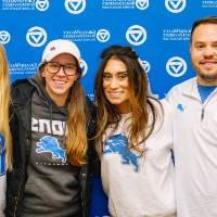 Doug and Christen Fox pose for a photo with two fellow GVSU alumni